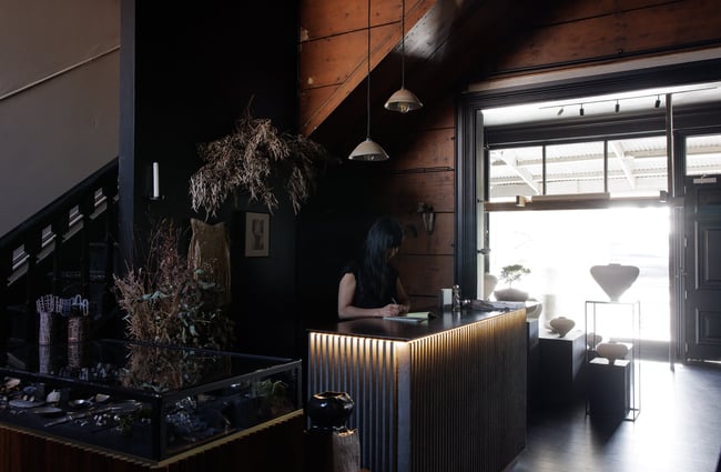 A woman working at the counter at Public Record Auckland.