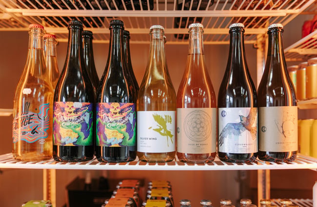 Bottles of beer inside a fridge.