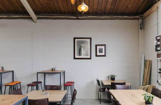 Tables and artwork on the wall at Punky Brewster.