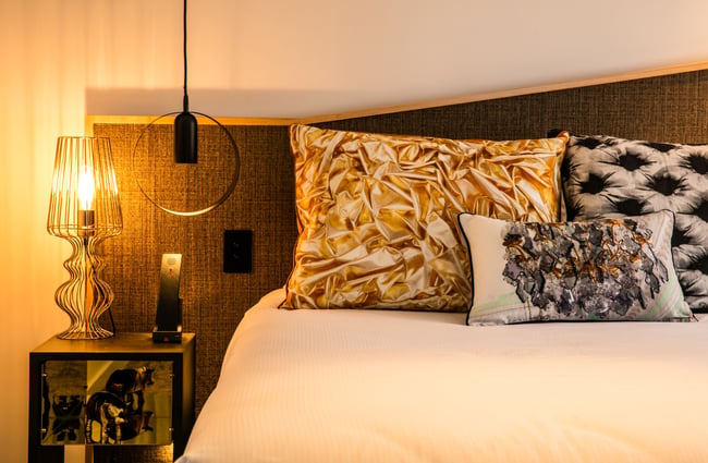 A made up bed inside a hotel room.