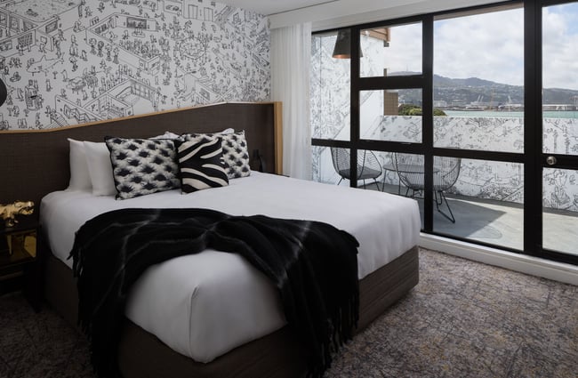 A large bed in a hotel room.