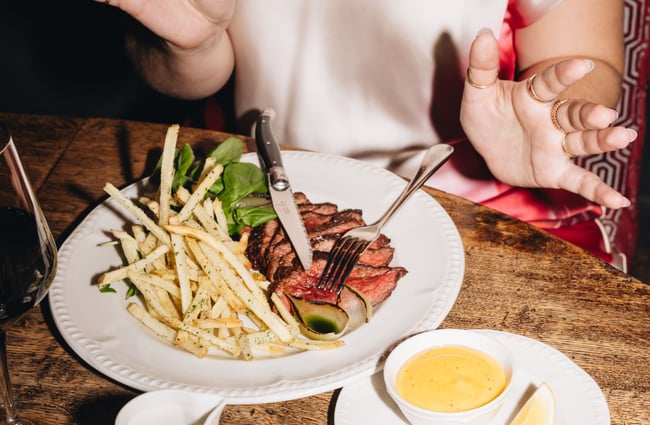 Steak and fries on a plate.