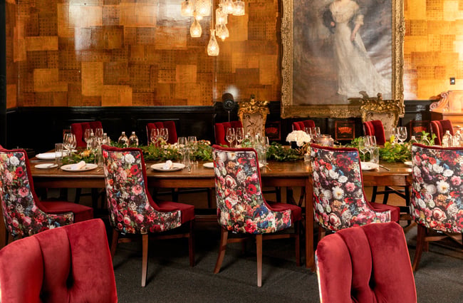 Floral dining chairs around a table.