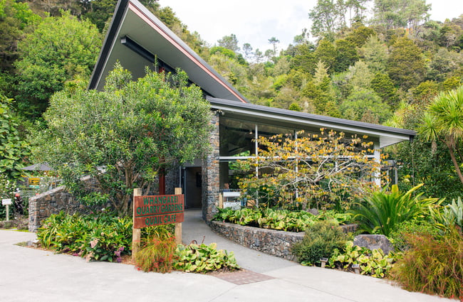 Exterior of Quail Cafe surrounded by lush gardens.
