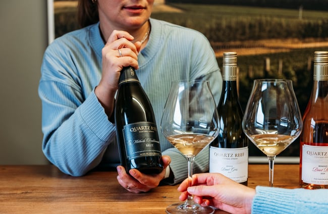 Winemaker holding a bottle of wine at Quartz Reef.