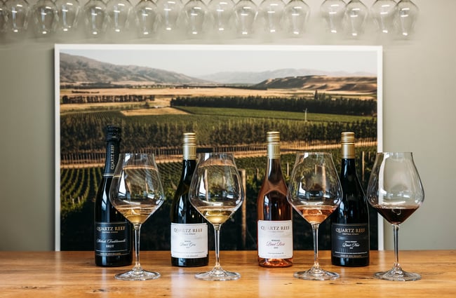 Lineup of bottles and glasses of wine at Quartz Reef.