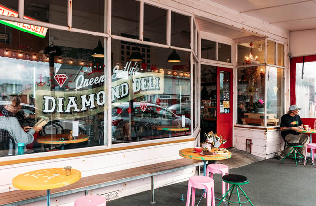 Outdoor street seating area at Queen Sally's Diamond Deli in Lyall Bay Wellington
