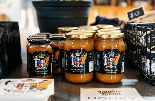 A close up of jars on honey.