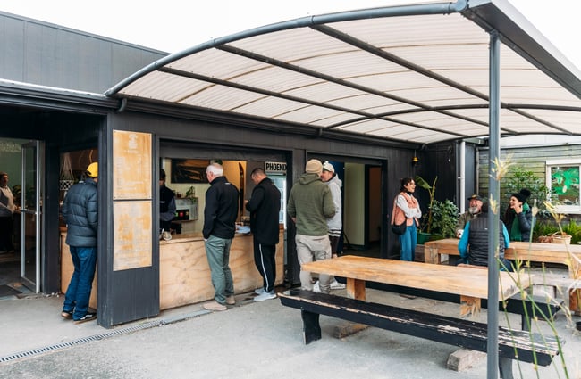 Customers waiting for their coffee order outside Raglan Roast.