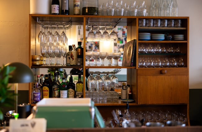 Glasses and wine bottles behind the counter at Ragtag.