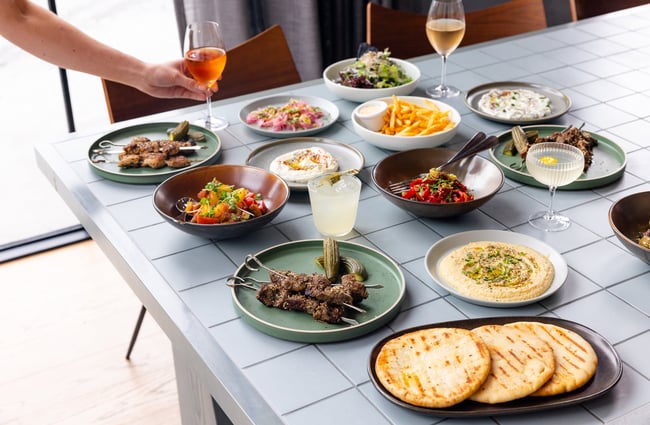 Multiple food dishes on a table at The Rambler.