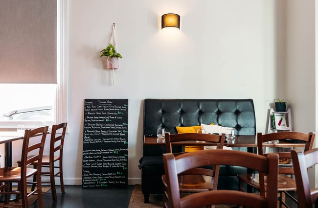 Blackboard menu at Rata's Kitchen next to dining table