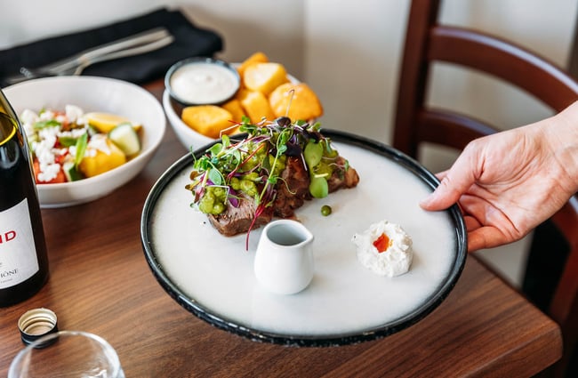 Lamb rump dish getting placed on table at Rata's Kitchen in Petone