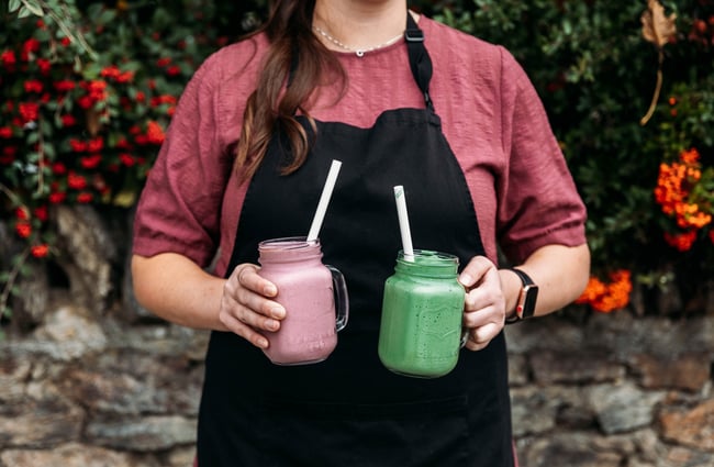 Smoothies being held up outside Recharge Bar & Cafe.