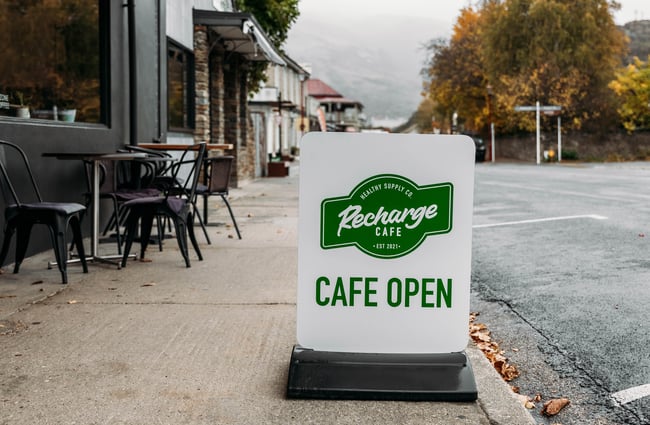 Recharge Bar & Cafe signage outside on the footpath.