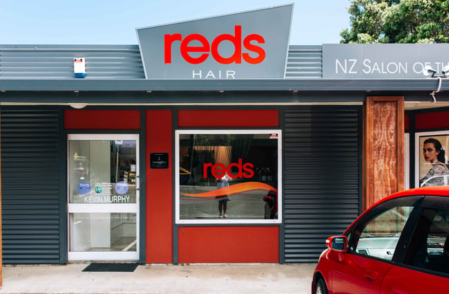 Red salon with corrugated iron features.