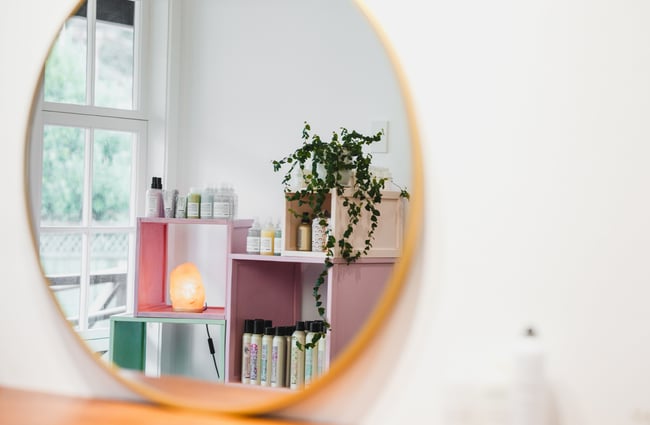 Reflection of products in mirror at Refuge Hair Boutique, Wellington.