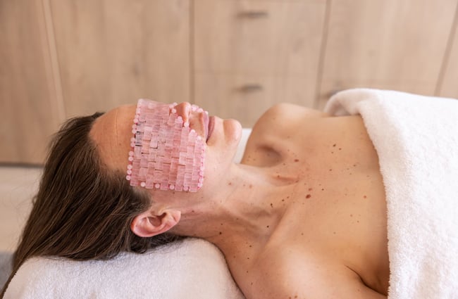 Client during a treatment with an eye mask on at Renaissance.