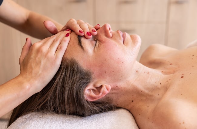 Client getting a facial massage during a facial at Renaissance.