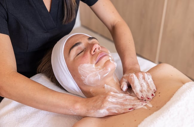 Close up of woman receiving a facial.