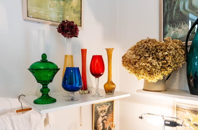 Coloured large stemmed glasses in a white room.