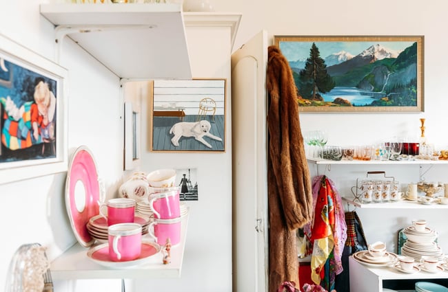 Vintage wares and pink antique cups on shelves.