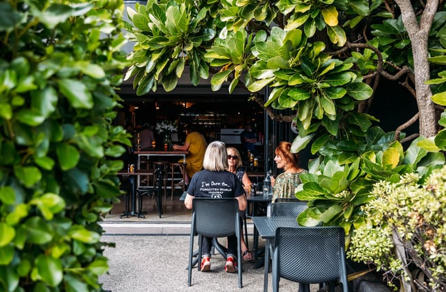 Women dining in outdoor garden space at Revive Espresso in Petone