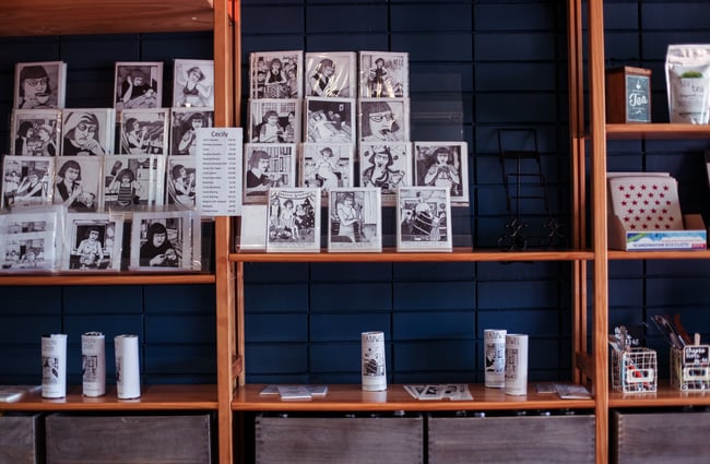 Black and white art on wooden shelves.