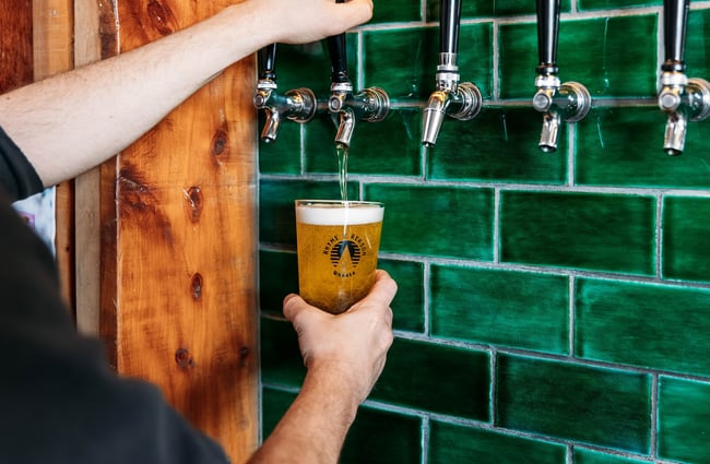Close up of a beer being poured from a tap at Rhyme x Reason, Wānaka.