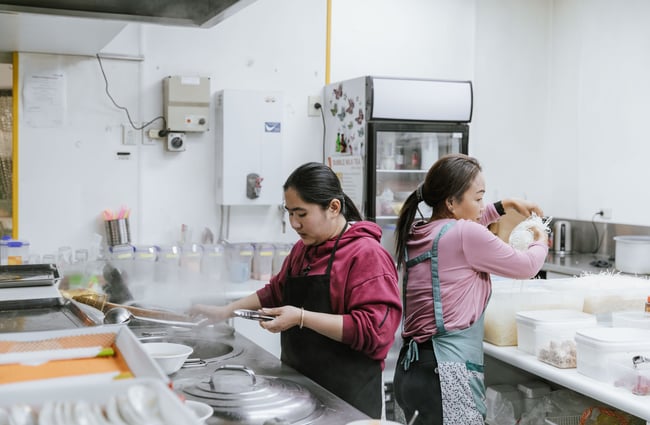 Two chefs working in the kitchen.