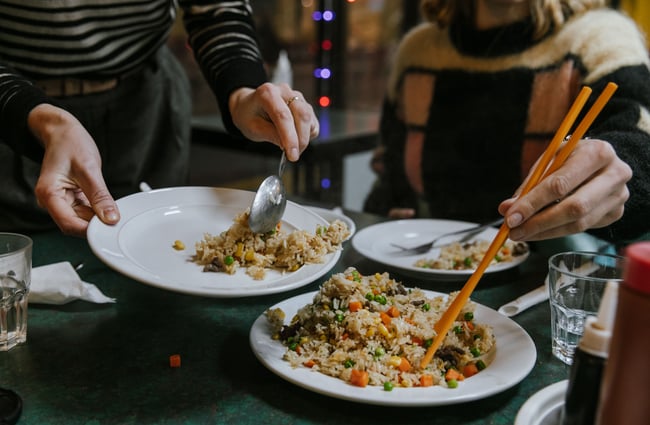 Close up of customers serving themselves fried rice.