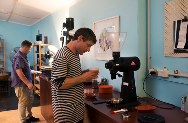 Two men making coffee.