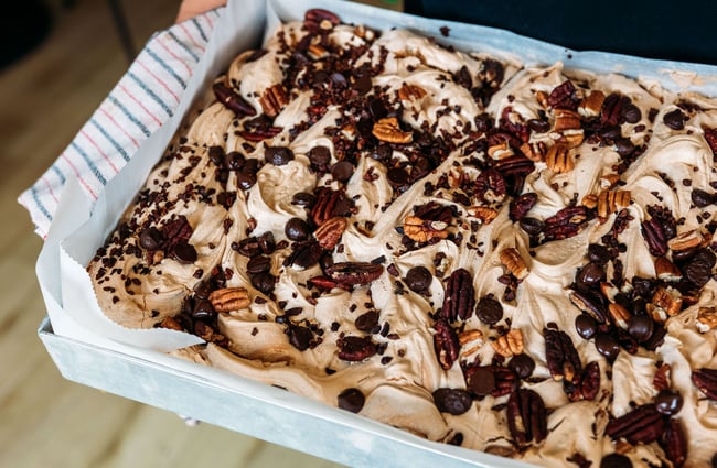 Close up of tiramisu style dessert served inside a big dish