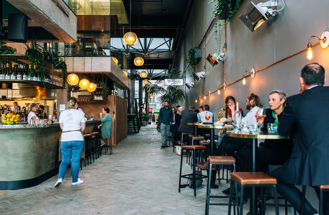 Customers dining inside Mr Pickles a restaurant within Riverbank Lane.