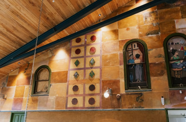 Wall showcasing art work and stone.