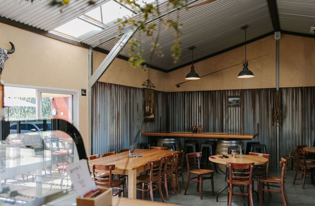 The indoor seating area inside the River-T Estate with wooden tables.