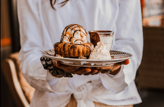 Woman holding dessert from Rollickin' Gelato.