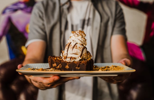 Man holding a dessert from Rollickin Gelato.