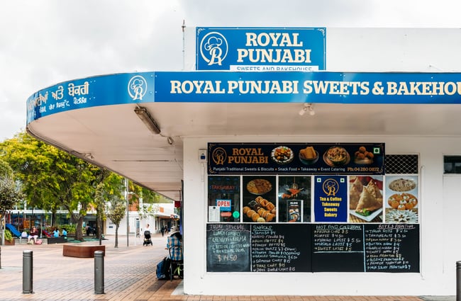 Exterior view of the corner shop Royal Punjabi Sweets and Bake House.