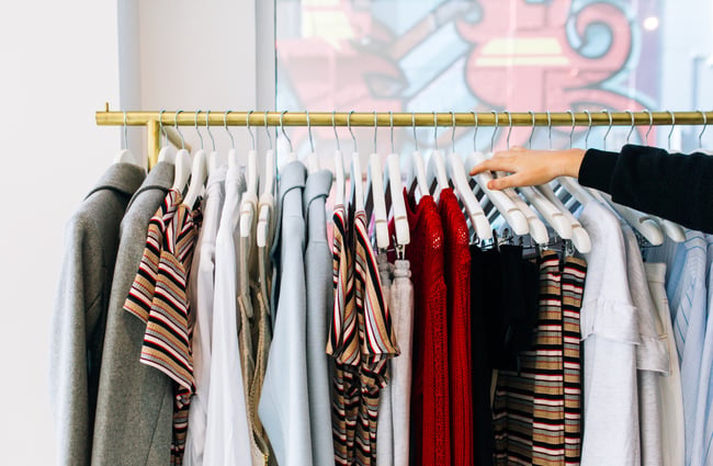 Hand arranging clothes at RUBY Hamilton.