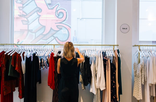 Worker looks through clothes at RUBY, Hamilton.