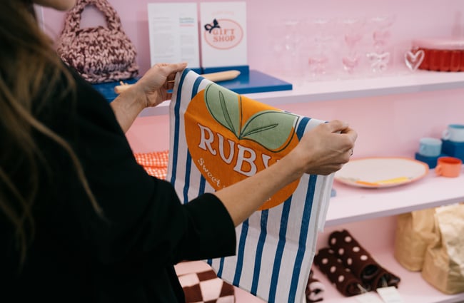 Person holding up Ruby homeware accessory at The Crossing in Christchurch