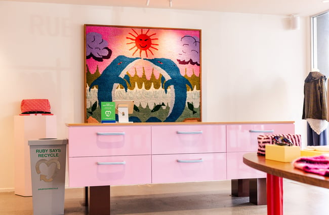 A pink chest of drawers in a retail store.