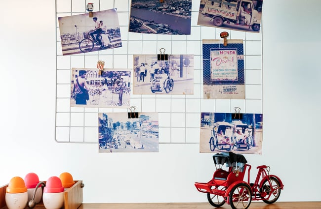 Vintage photographs are used as decor on the walls in Saigon '60s.