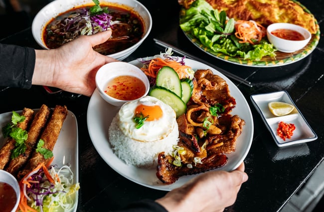 A table laden with food dishes from Saigon '60s.