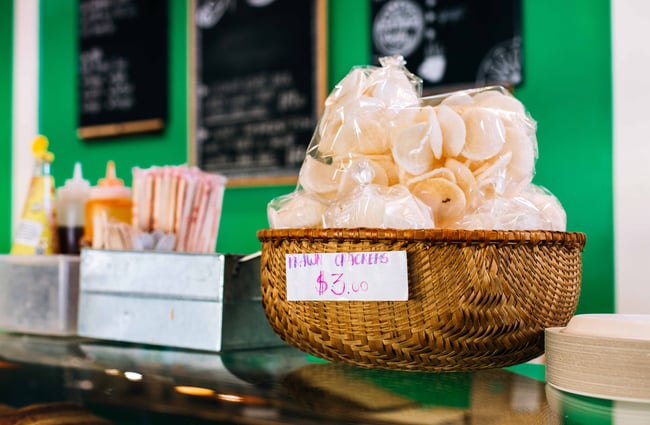 Close up of crackers in a woven basket at the counter.