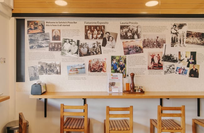 The bench seating along the wall at the Salvito's Pizza Bar..