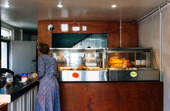 Woman orders food at the counter.
