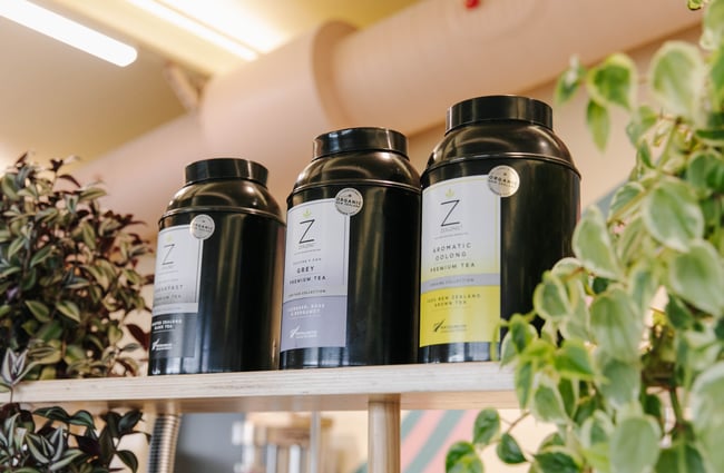Close up of tea containers with plants.