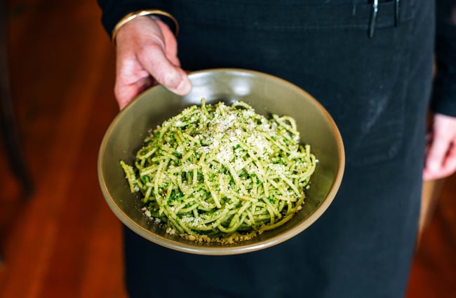 Waiter holding a bowl of courgette noodles from Scotts Epicurean.